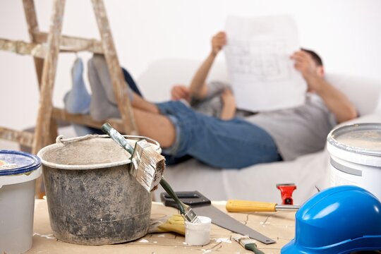 Couple taking break of painting house