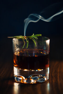 Glass of whiskey with rosemary