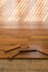 Vertical blinds cast shadows on a newly installed Brazilian Cherry hardwood floor with planks ready...