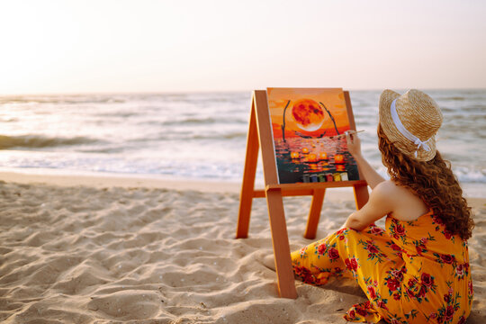 Creative female artist drawing the picture at the beach. Art, creativity and inspiration concept. Canvas Painting.