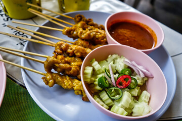 Satè sticks with cucumber and curry in Bangkok, Thailand