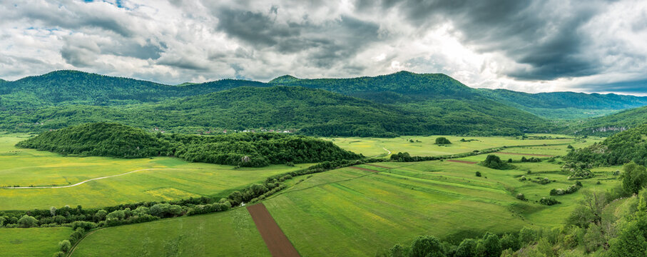 Panorama of Lipovo polje (linden field) and Velebit mountain in the bačkgorund. View from Kosinj (Denison) village. Lika, Croatia.