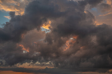 Obraz premium a dark thundercloud on the background of sunset