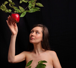Portrait of a young beautiful girl in the image of a primitive woman. The girl stretches out her...