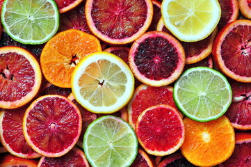 Slices of red sicilian oranges, tangerine, lemon and lime background - obrazy, fototapety, plakaty
