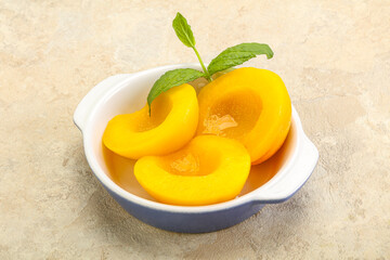 Sweet ripe canned peaches with mint