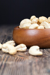 pile of cashew nuts on the table and in a wooden plate while eating