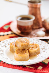 Bosnian and Turkish dessert called Ruzica served in a traditional way with coffee
