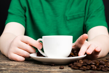 a red-haired boy drinking tea