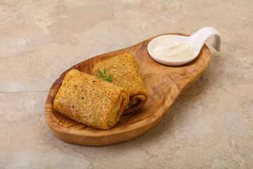 Staffed pancakes served sour cream