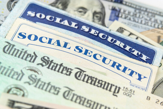 Close Up View Of Social Security Cards And United States Treasury Checks.