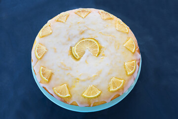 lemon cake with sugar glaze, blue background