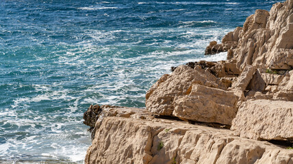 The waves of the Adriatic Sea crashing on the rocky shore of the island of Hvar in Croatia