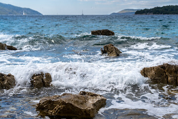 The waves of the Adriatic Sea crashing on the rocky shore of the island of Hvar