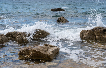 The waves of the Adriatic Sea crashing on the rocky shore of the island of Hvar