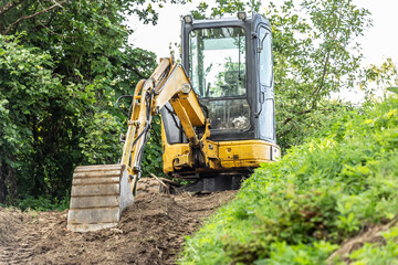 A mini excavator on a building yard in a garden