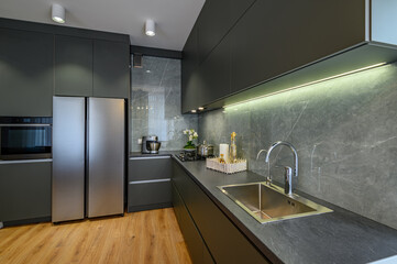 Modern large luxury dark gray kitchen closeup - obrazy, fototapety, plakaty