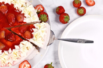 Slice of strawberry fruit cream cake on cake server