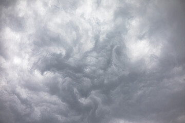 Light and dark grey storm clouds waves over the sky before heavy rain. Dramatic cumulonimbus, moody...