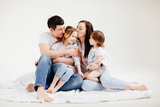 beautiful happy family cuddling in a white photo studio. backstage.