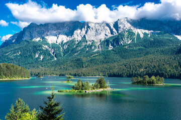 Faboulus landscape of Eibsee Lake with turquoise water in front of Zugspitze summit under sunlight. Location: Eibsee lake, Garmisch-Partenkirchen Bavarian alps, Germany, Europe - obrazy, fototapety, plakaty