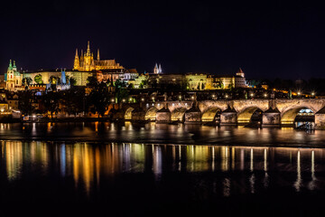 Fototapeta na wymiar PRAGUE, CZECH REPUBLIC, 31 JULY 2020: beautiful reflection of the Castle of Prague and the Charles Bridge at night