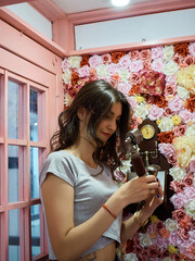 women in a pink phone booth 