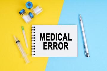 A syringe, ampoules and a notebook with the inscription - MEDICAL ERROR