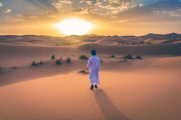 Fototapeta premium Berber man wearing traditional clothes in the Sahara Desert at dawn, Morocco