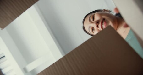 Excited Asia young woman unpack opening huge carton box and looking inside new clothes gift at home. Happy millennial lady client satisfied with ordered purchase. Delivery and online shopping concept. - Powered by Adobe