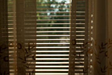 The blinds are made of wood. View of the blinds from above.