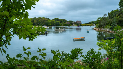 Tranquil seascape with moored boats under a dramatic sky. Sulky cloudscape over the tranquil marina. Mooring yachts and boats.