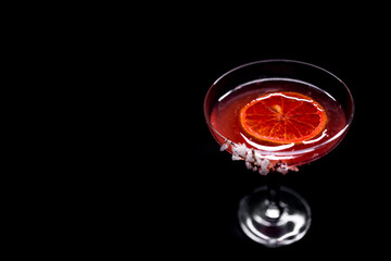 hemingway daiquiri cocktail drink with grapefruit in glass on black background