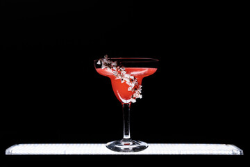 hemingway daiquiri cocktail drink with grapefruit in glass on black background