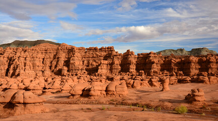 Fototapeta premium bizarre hoodoos and colorful eroded hills on a sunny day at goblin valley state park, utah