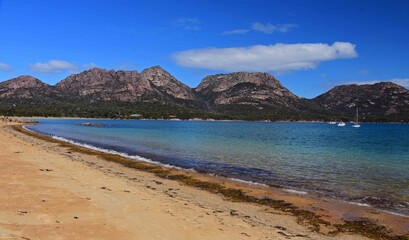 the spectacular  granite mountain range of the hazards peaks overlooking honeymoon bay in freycinet national park, tasmania, australia