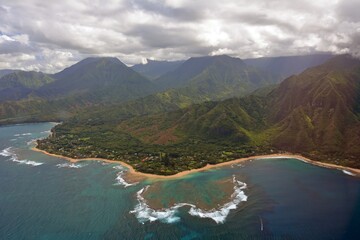 the town of princeville and coral reefs on the north shore of  kauai, hawaii, as seen from a helicopter