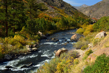 a beautiful fall scene of the foothills and rapids of the south platte river in waterton canyon near littleton, colorado
