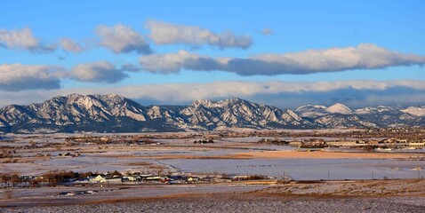 beautiful early morning view of the snowy front range and rock creek farm, from broomfield,...