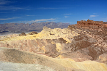 view of manly beacon from zabriskie point on a sunny day in death valley national park, california