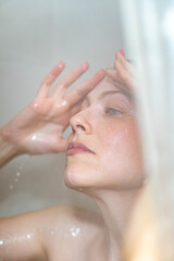 Naklejka premium Blond woman with blue eyes in the shower