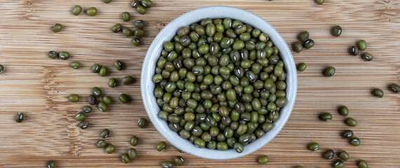 Green bean or mung bean or moyashi bean on wooden table background. Size for banner.