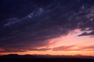 colorful purple-hued sunset  over the front range of the colorado rocky mountains, as seen from broomfield, colorado