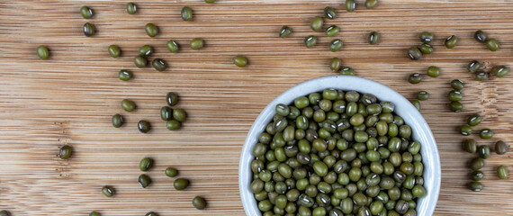 Green bean or mung bean or moyashi bean on wooden table background. Size for banner.
