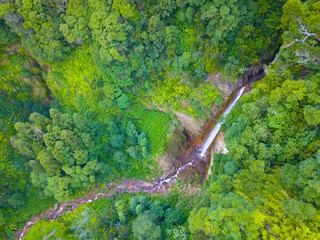 Aerial drone view of a huge tropical waterfall in Sao Miguel, Azores islands.