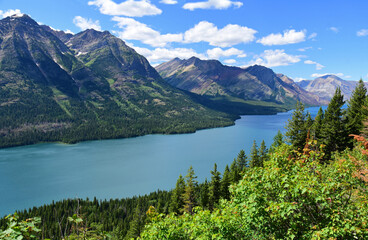 Fototapeta na wymiar the spectacular peaks, lake and forests of waterton lakes national park and glacier national park, as seen in summer from the goat haunt overlook, in goat haunt, montana