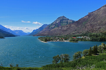 the spectacular view on a sunny day across turquoise-colored waterton lakes to prince of wales...