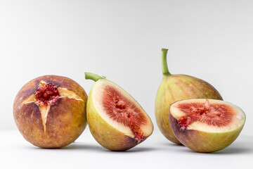 White background photo of figs cut in half.