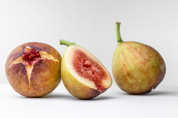 White background photo of figs cut in half.