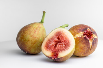 White background photo of figs cut in half.